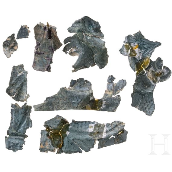 Ten fragments of a Roman helmet, partly pieced together from shards, late 2nd &ndash; first half of the 3rd century.
