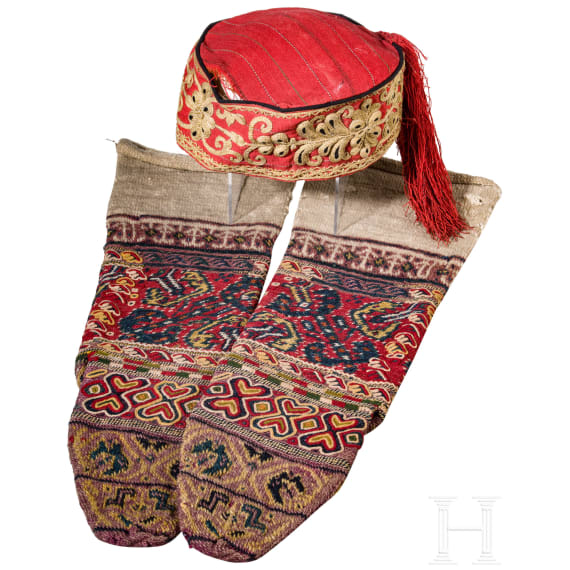 A Ottoman cap and two woollen stockings