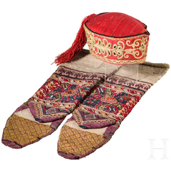 A Ottoman cap and two woollen stockings
