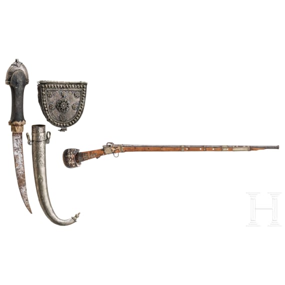 A yemenite matchlock rifle with cartridge pouch and Khoumya, 19th and 20th century