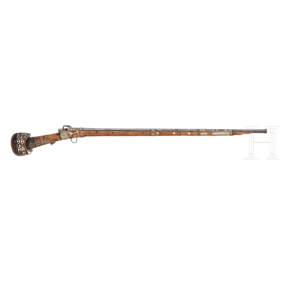 A yemenite matchlock rifle with cartridge pouch and Khoumya, 19th and 20th century