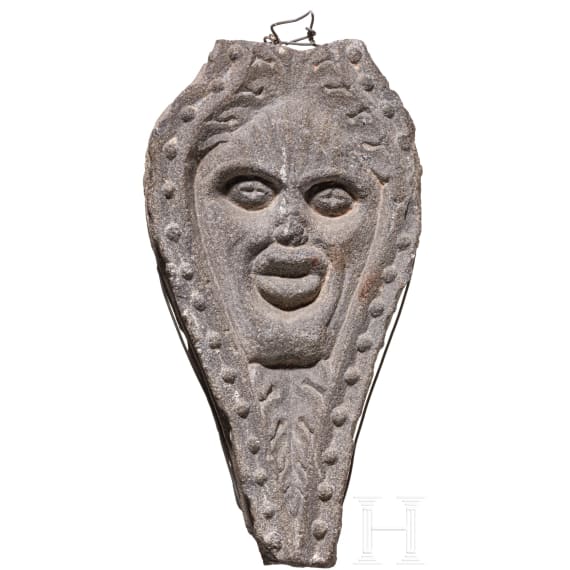 An English or Brittany basalt relief with the head of Green Man, 16th century