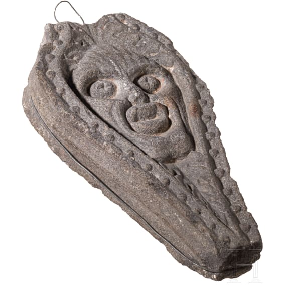 An English or Brittany basalt relief with the head of Green Man, 16th century