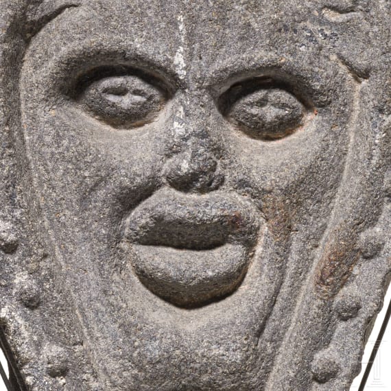 An English or Brittany basalt relief with the head of Green Man, 16th century