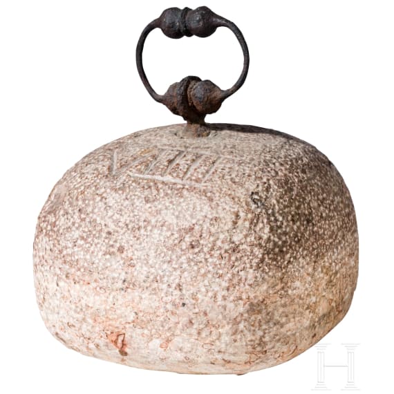 A German stone weight of nine pounds with iron handle, 17th century