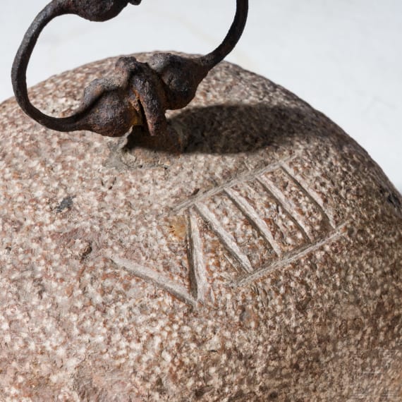 A German stone weight of nine pounds with iron handle, 17th century