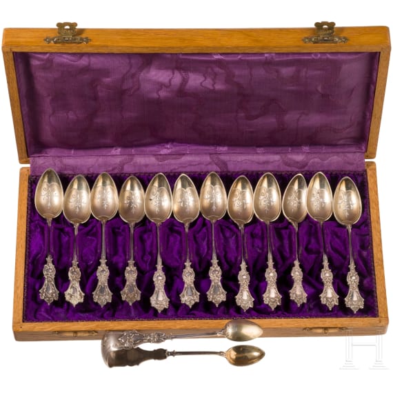 Twelve silver partial-gilt tea spoons and a sugar tong with a case, stamped Russia, circa 1880