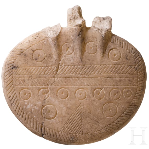 An alabaster disc decorated with incised patterns, a fragment of an Early Bronze Age idol, Cappadocia, late 3rd millennium B.C.