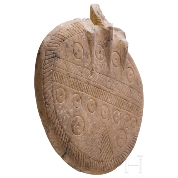 An alabaster disc decorated with incised patterns, a fragment of an Early Bronze Age idol, Cappadocia, late 3rd millennium B.C.