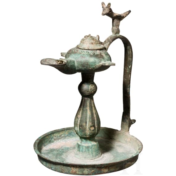Bronze oil lamp on a disc-shaped base with floral and figurative decoration, Seljuk, 12th&ndash;13th centuries
