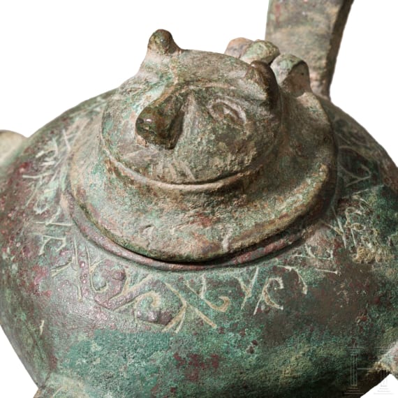 Bronze oil lamp on a disc-shaped base with floral and figurative decoration, Seljuk, 12th&ndash;13th centuries