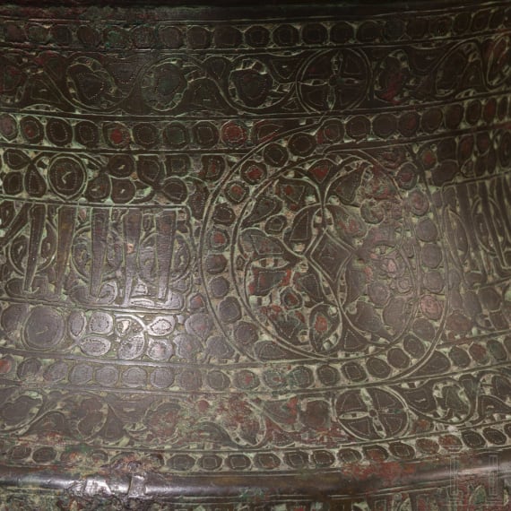 Bronze base of a candlestick, entirely chased with floral and figurative motifs, as well as inscriptions; Seljuk, 12th&ndash;13th centuries