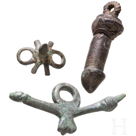 Two bronze phallic amulets and a spur, Roman, 2nd&ndash;3rd centuries.