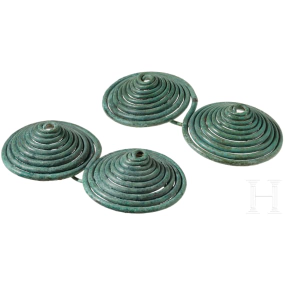 A pair of Early Iron Age bronze fibulae with a double spiral and an olive-green patina, 9th&ndash;8th centuries B.C.