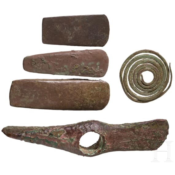 Five Copper Age artifacts: three flat axes, one axe with diagonally set edges, and a decorative spiral; Southeastern Europe, late 5th millennium &ndash; 4th millennium B.C.