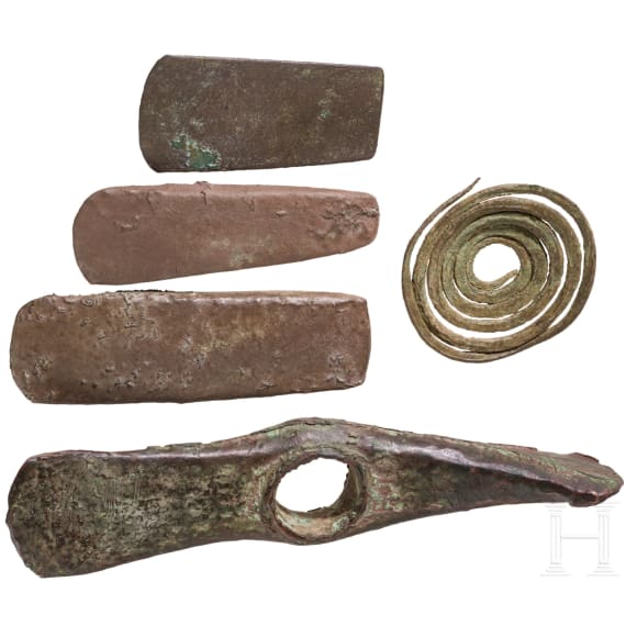 Five Copper Age artifacts: three flat axes, one axe with diagonally set edges, and a decorative spiral; Southeastern Europe, late 5th millennium &ndash; 4th millennium B.C.