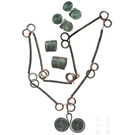 A set of Bronze Age jewellery, strung in modern times, together with two finger rings and two curl rings, 10th&ndash;9th centuries B.C.