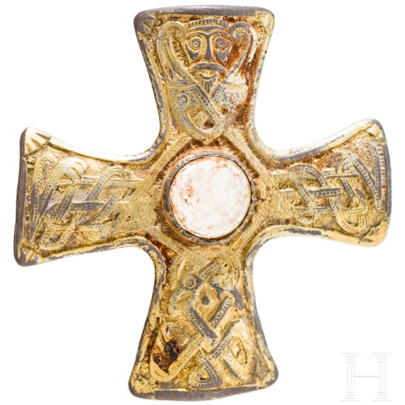 A brooch made of gold-plated silver in the shape of a cross, depicting Odin and his ravens, Viking, 10th century.