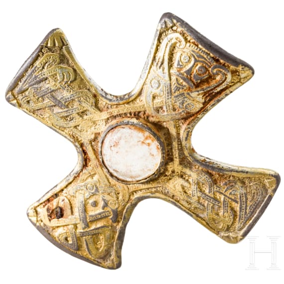 A brooch made of gold-plated silver in the shape of a cross, depicting Odin and his ravens, Viking, 10th century.