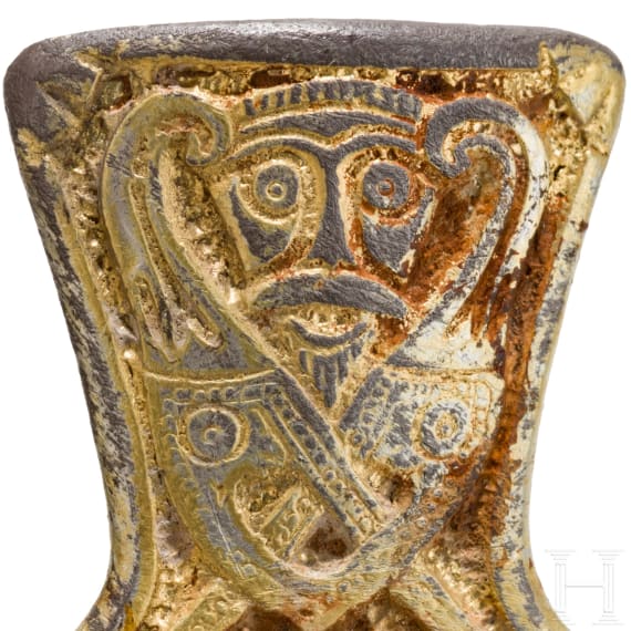 A brooch made of gold-plated silver in the shape of a cross, depicting Odin and his ravens, Viking, 10th century.