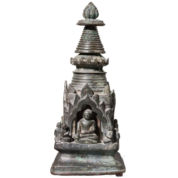 Bronze votive stupa with a reliquary chamber and depictions of Shakyamuni Buddha, flanked by two worshippers. Pagan Kingdom (Myanmar), 12th &ndash; 13th centuries.