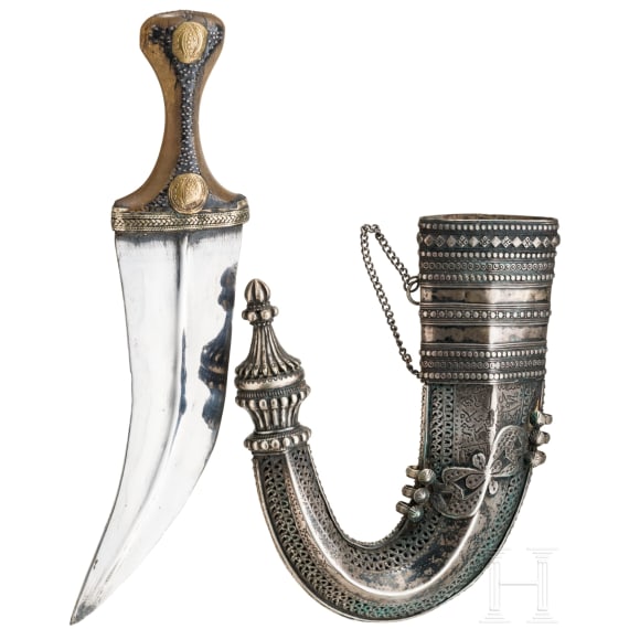 A Yemenite silver-mounted jambiya with rhino horn grip, dated 1942