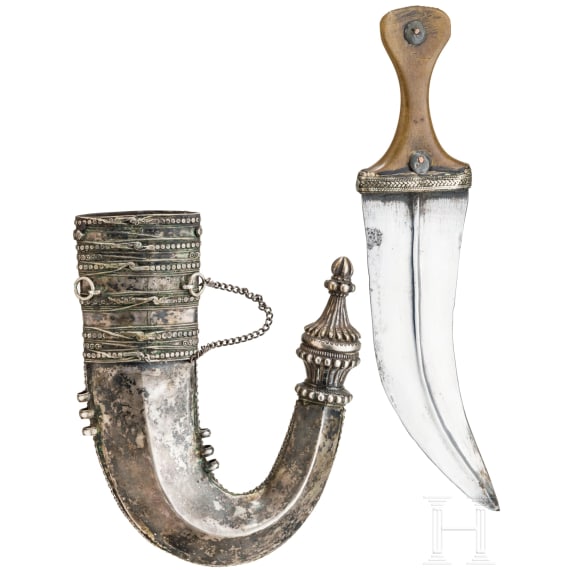 A Yemenite silver-mounted jambiya with rhino horn grip, dated 1942