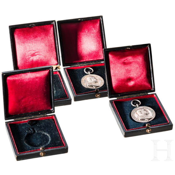 Two silver commemorative medals marking the 25th anniversary of King Charles's reign in 1889 and two cases