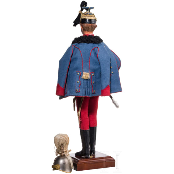 A miniature figure of an officer in the Austro-Hungarian Uhlan Regiment No. 5 and a miniature helmet, 20th century