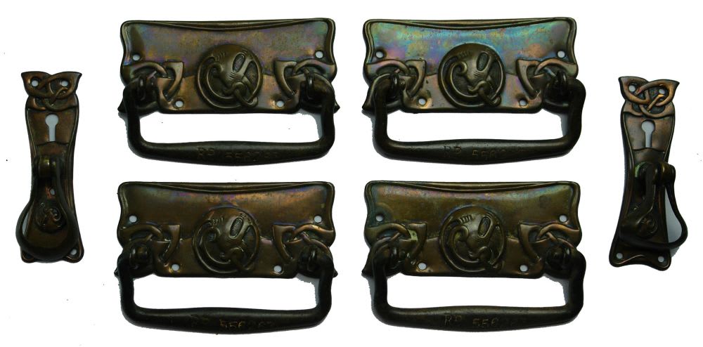 Ornate set of registered handles from an early piece of furniture.