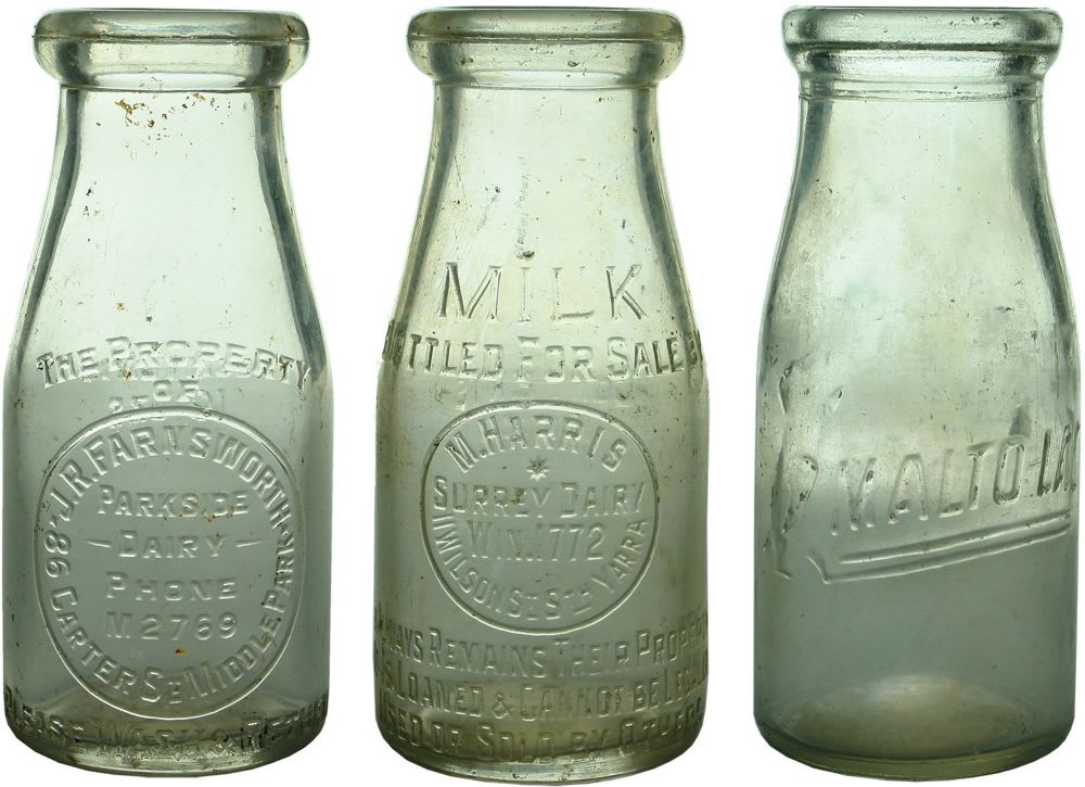 Three wide mouth half pint milk bottles