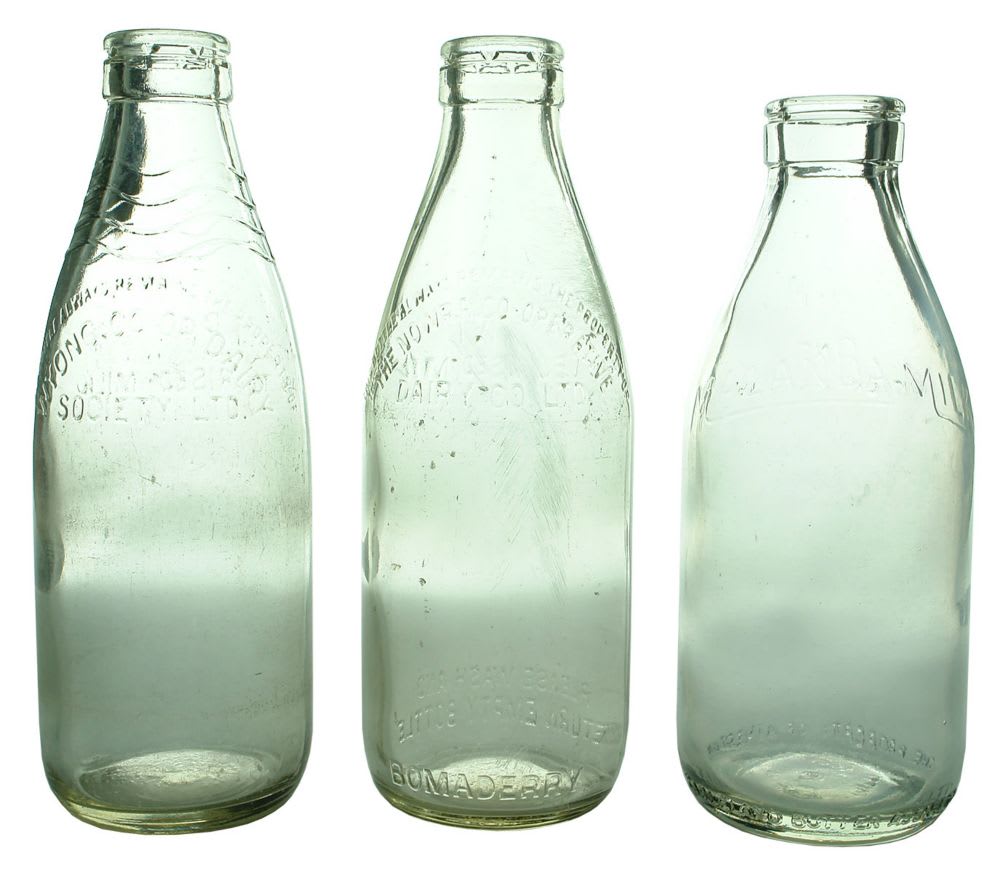 Three foil top milk bottles.