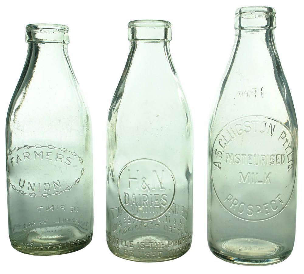 Three foil top milk bottles.