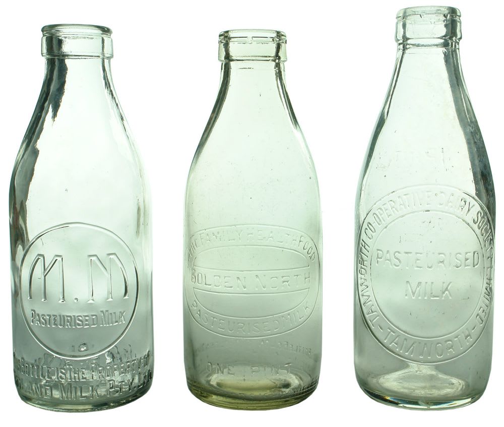 Three foil top milk bottles.