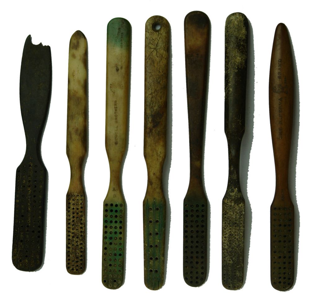 7 bone handled tooth brush handles.