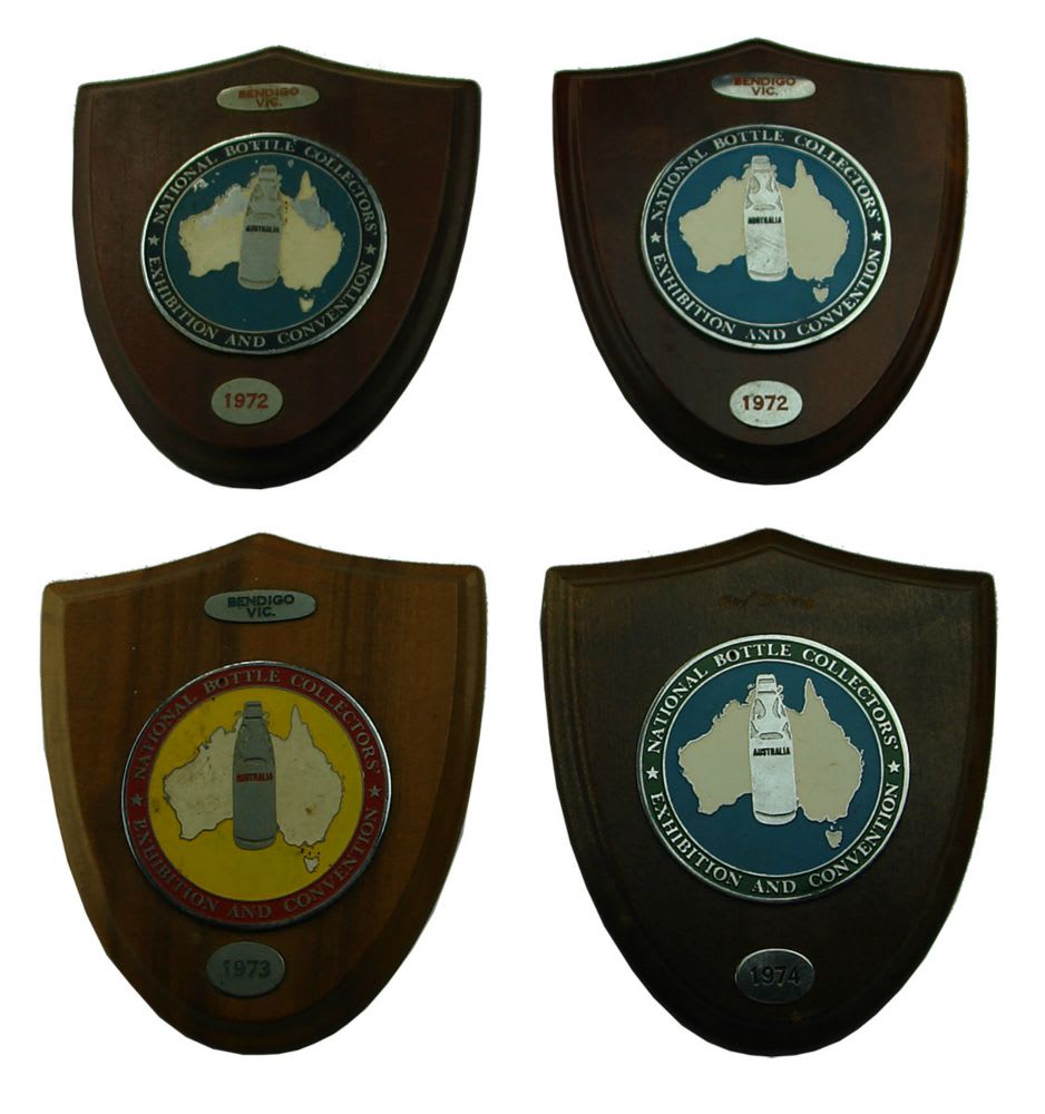 Four wooden shields with Enamel badges in the middle all for National Bottle Collectors Exhibition and Convention