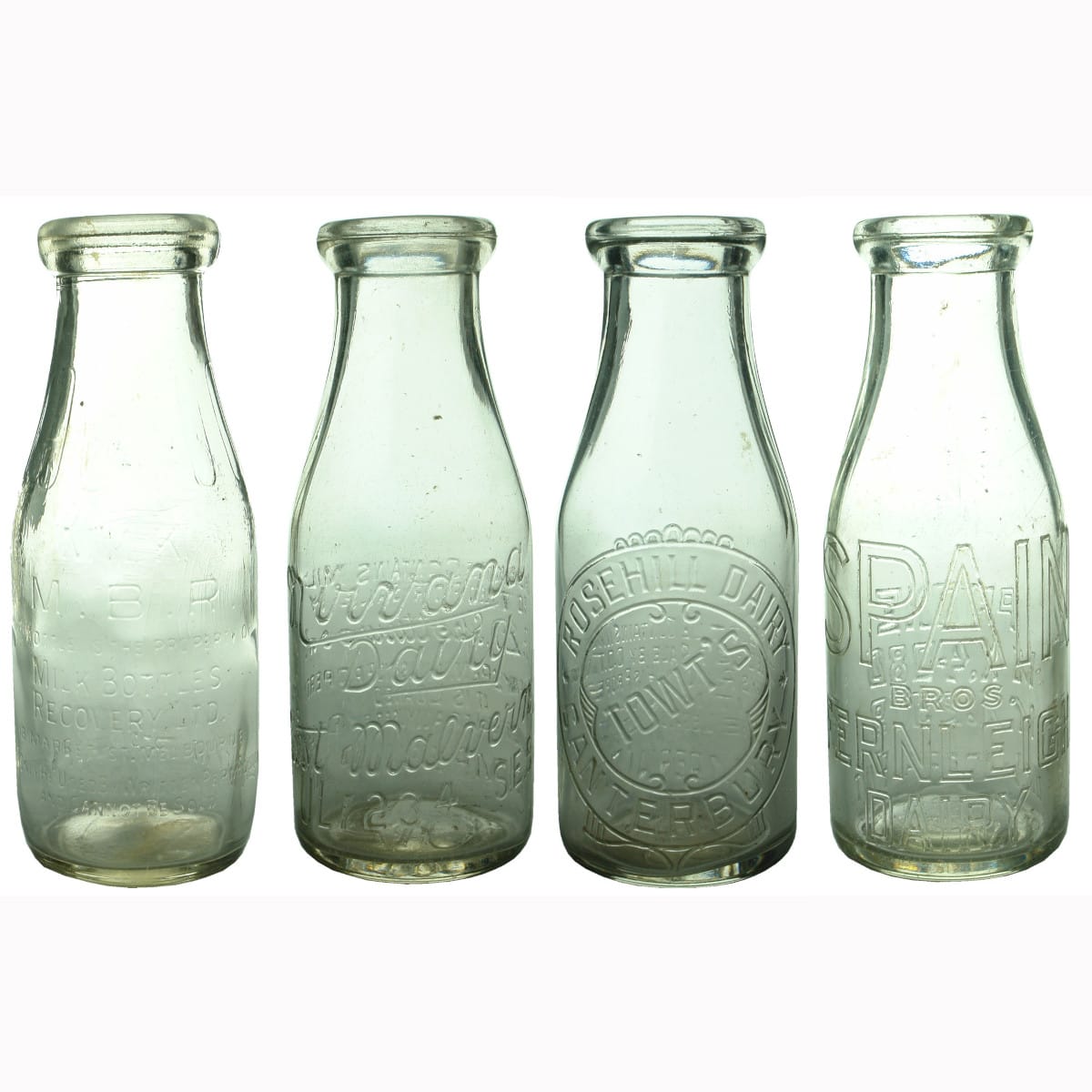 Four Pint wide mouth Milk Bottles: MBR, Nirvana Dairy, Rosehill Dairy and Fernleigh Dairy.