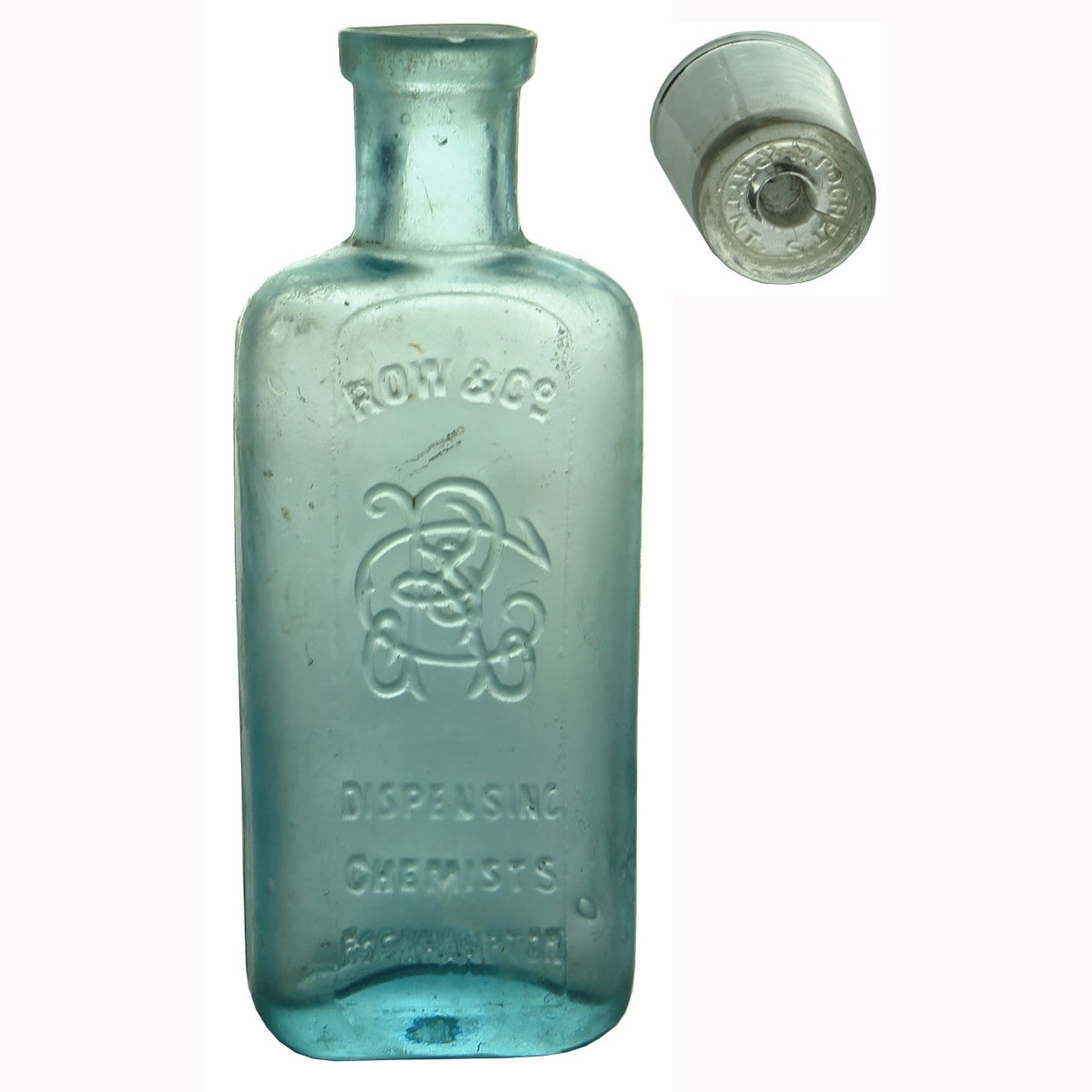 Chemist Bottle and a patent stopper. Row, Chemists, Rockhampton. Aqua. 2 oz.