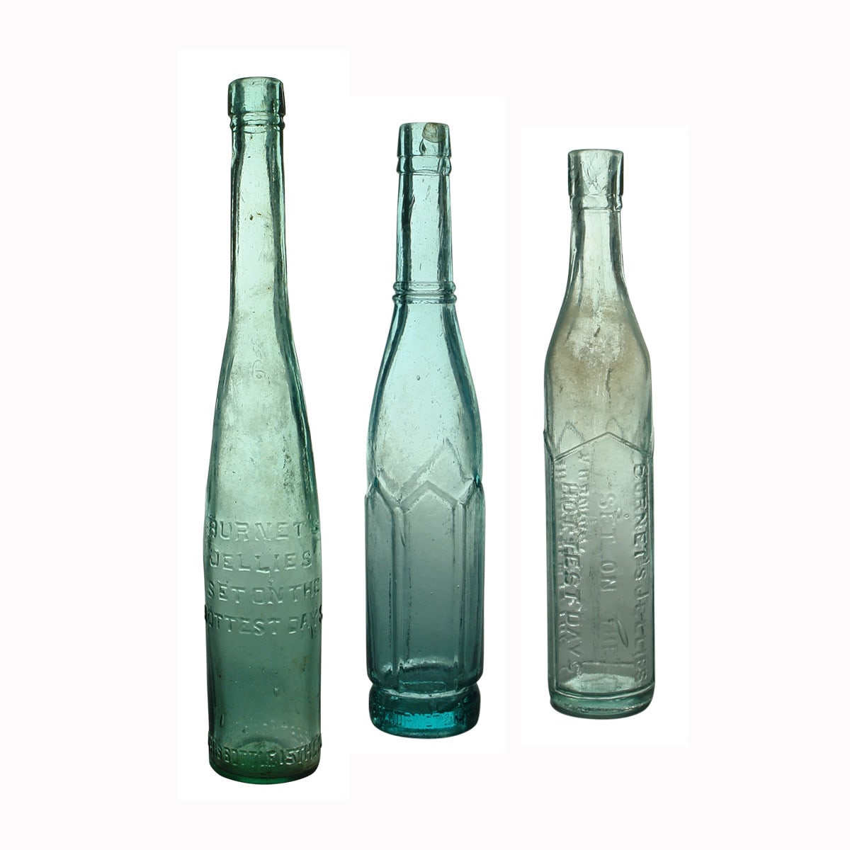 Three Burnet's advertising bottles.