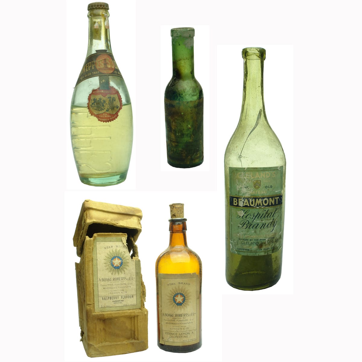 Four labelled bottles: Schweppes skittle; Capers; Boake Roberts Essence; Brandy/Kola.