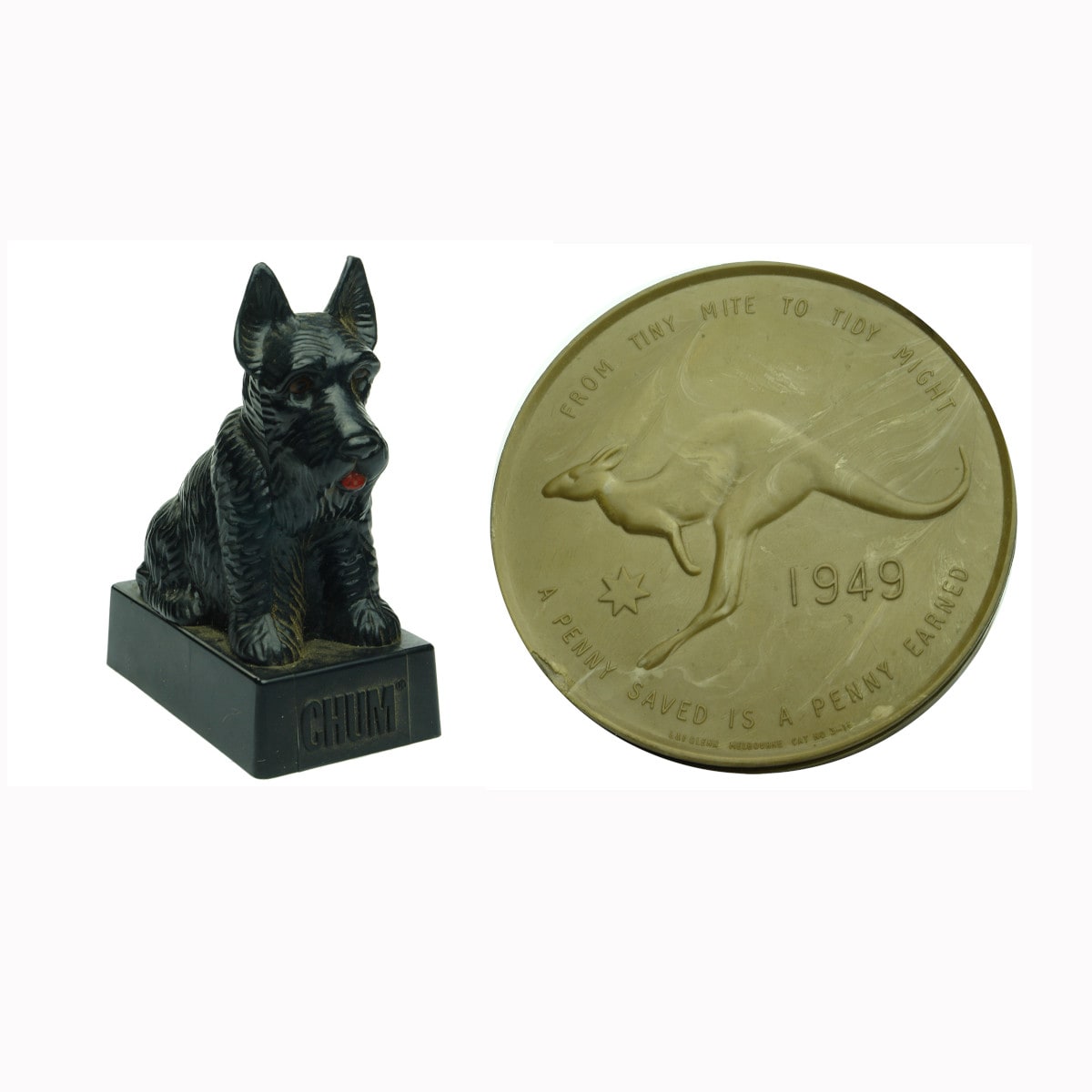 Two plastic Money Boxes. Chum advertising plastic dog and a 1949 penny shape.