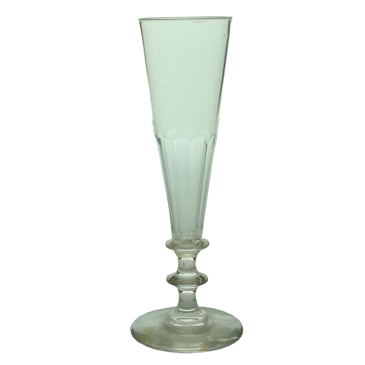 Glass. Georgian pontiled champagne glass with scalloped lower bowl and two knops to stem.