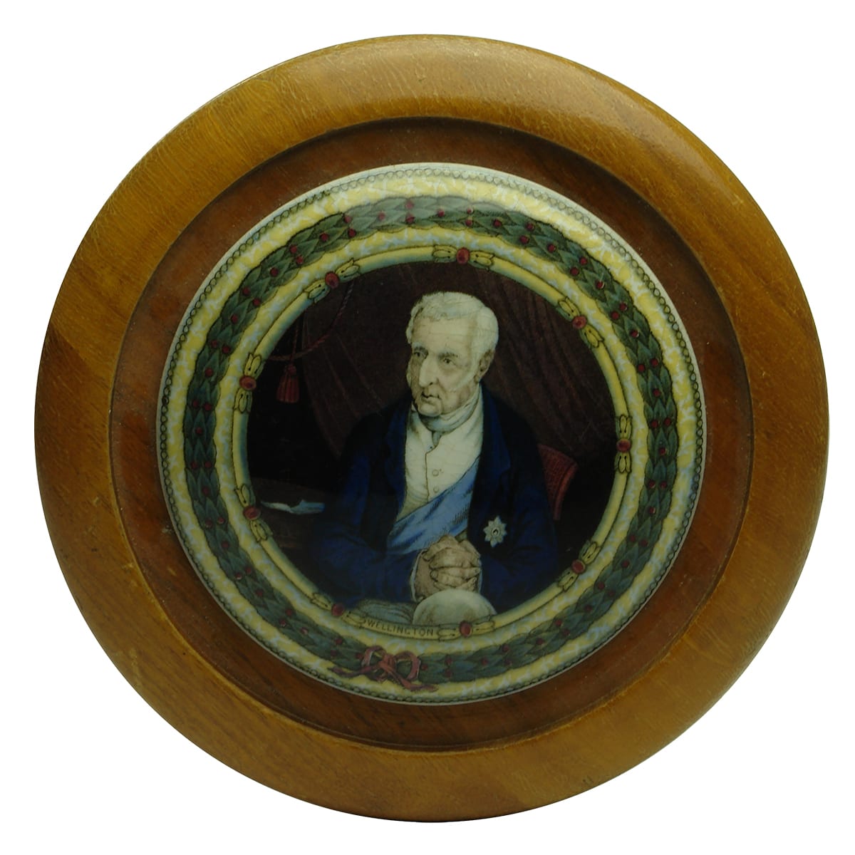 Prattware Lid. Wellington. Large decorative border. In a wooden frame.