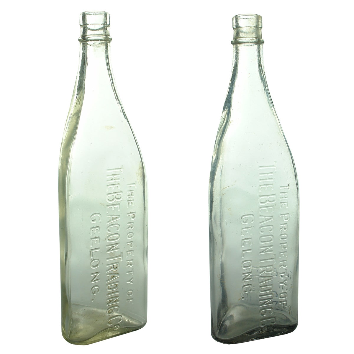 Two large Kerosenes. Different Beacon Trading Co., Geelong variations. Triangular. Clear. 32 oz. (Victoria)