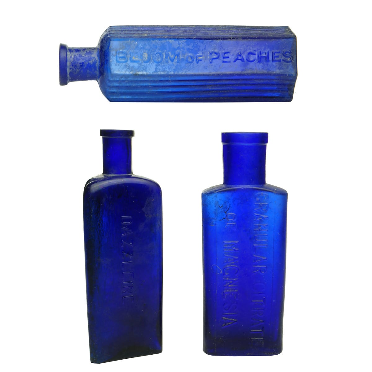 Three Cobalt Bottles: Dazzleine; Granular Citrate of Magnesia; Bloom of Peaches.