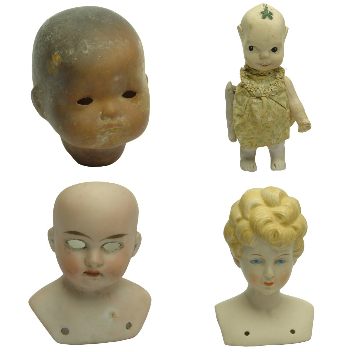 Four Bisque Dolls Heads.