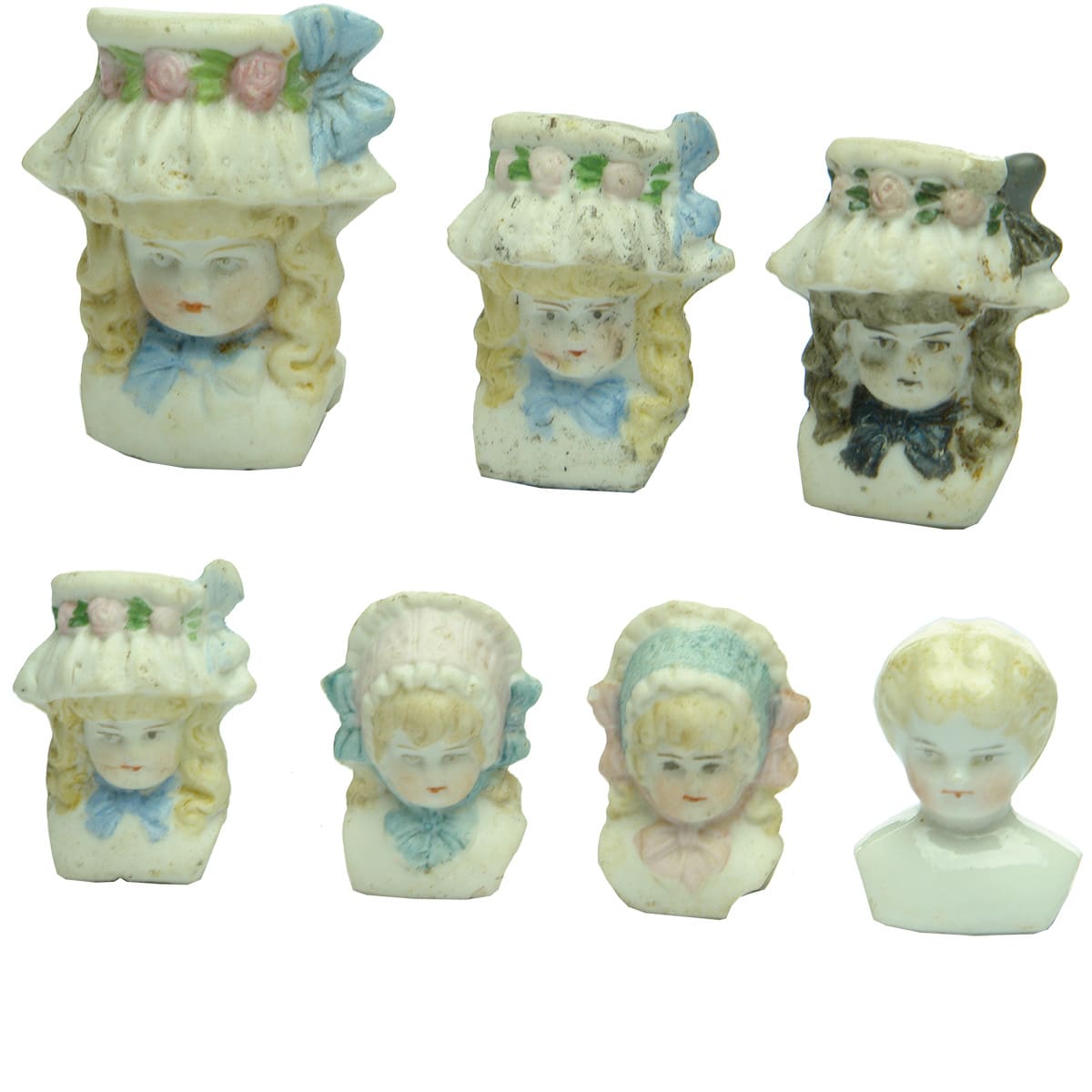 Seven different bonnet dolls heads