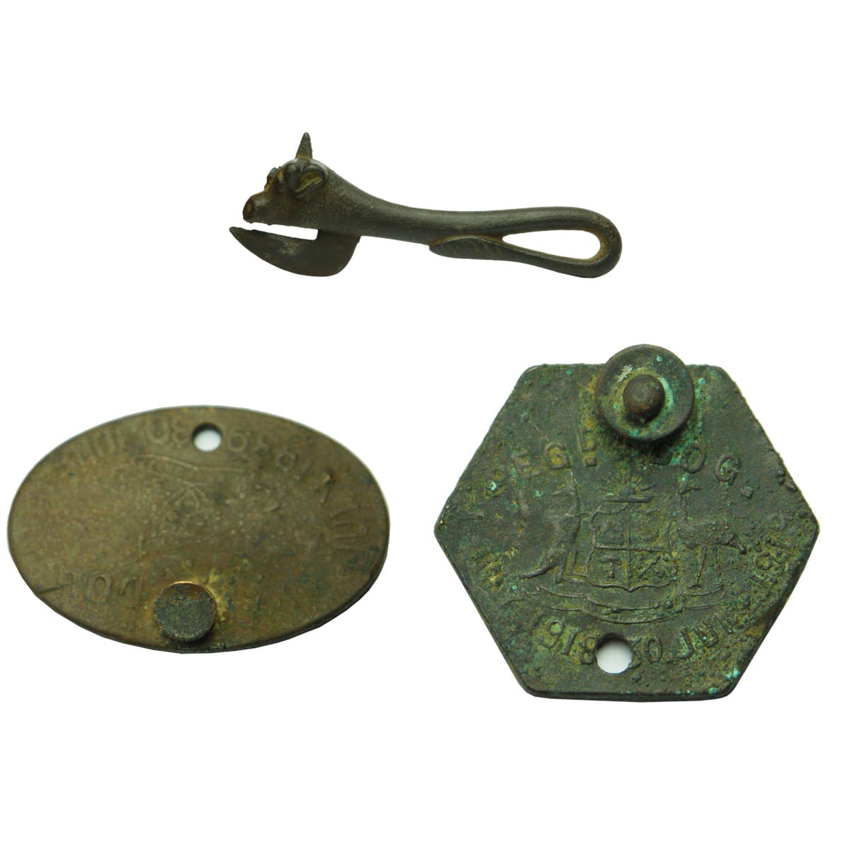 Three Items: 1. Cast Iron Opener. Shaped Like a Bull. 2. 1939/1940 Oval Dog Registration Tag. 3. 1918/1919 Hexagonal Dog Registration Tag.