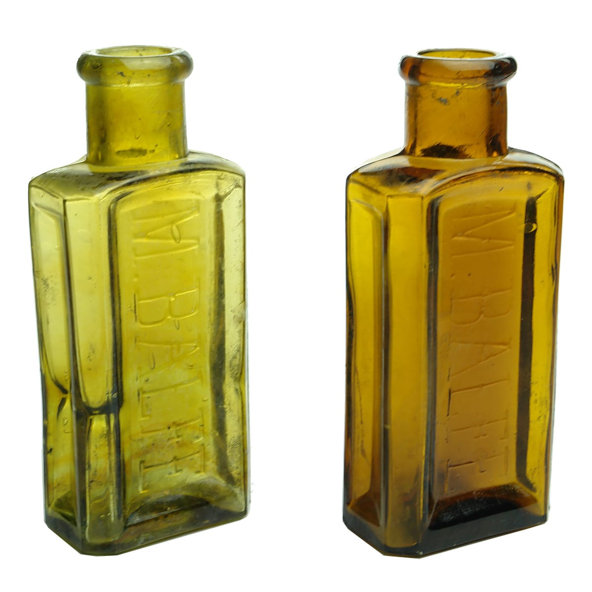 Pair of coloured M. Balfe hat dye bottles. Amber & Swirly Yellow Amber.