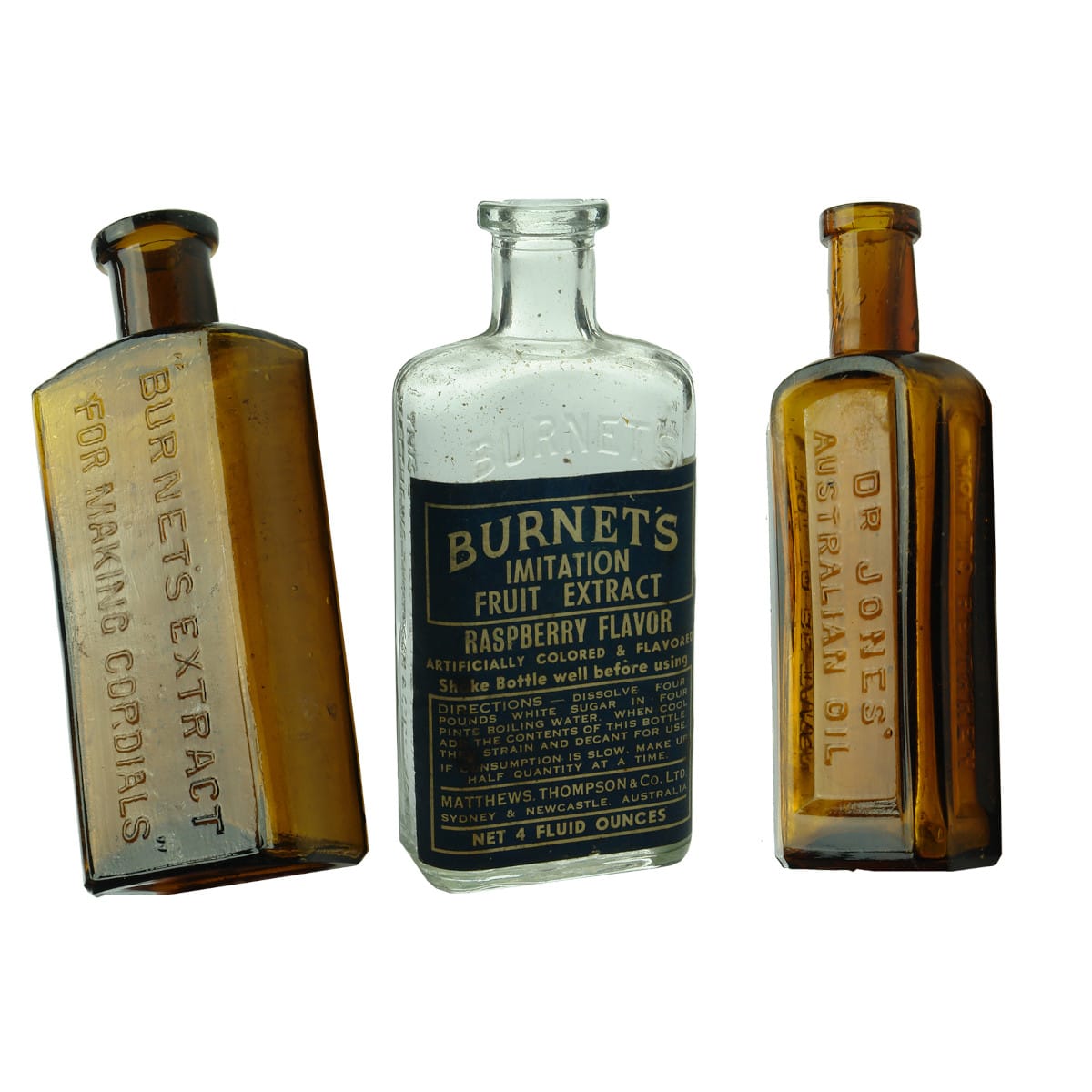 Three small bottles: Two different Burnet's Extract for Cordials (one labelled). Dr Jones' Australian Oil.